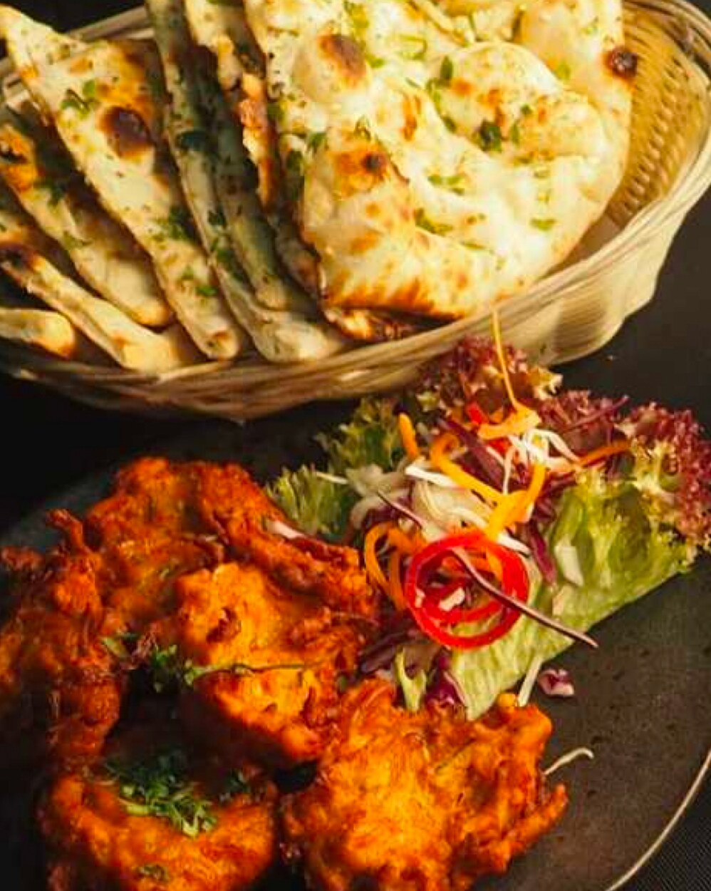 Basket of freshly baked naan and kulcha