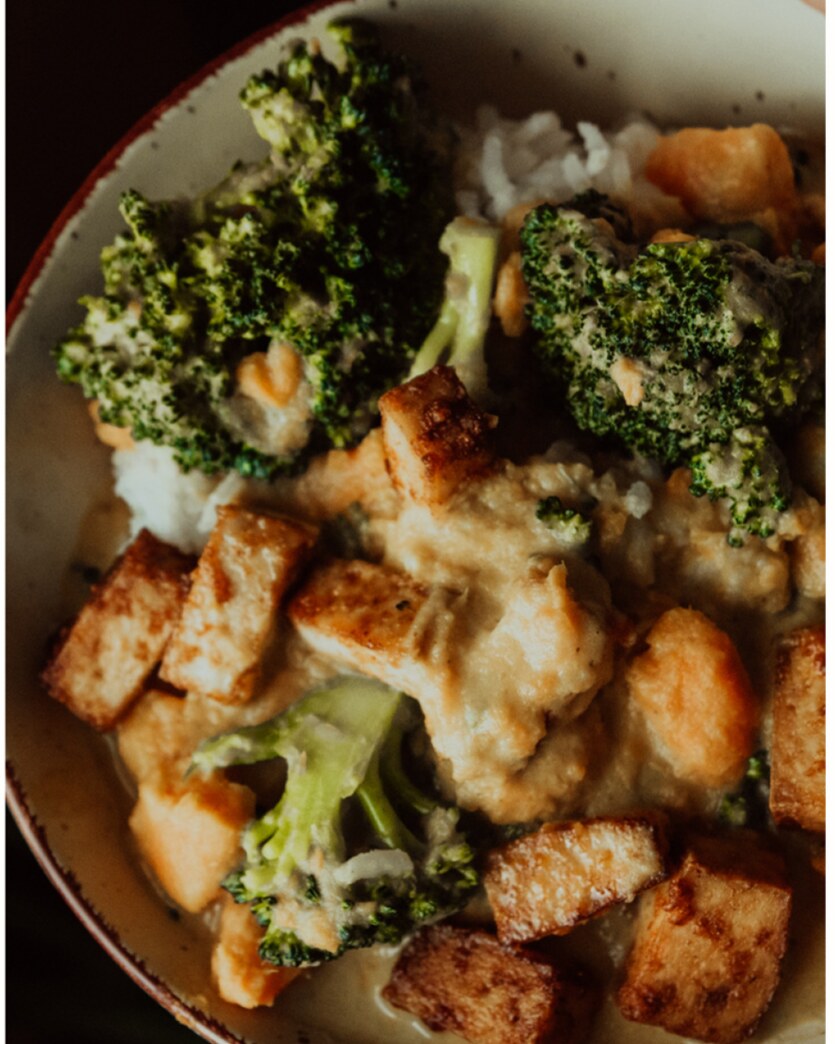 Bowl of stir-fried paneer and broccoli over rice