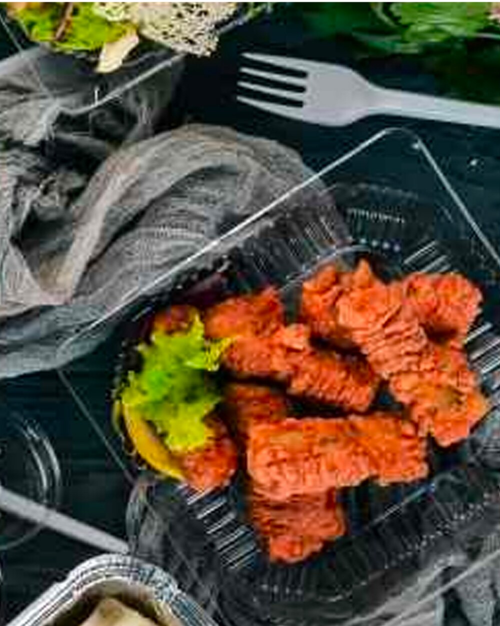 Marinated tandoori pieces served on a dark tray