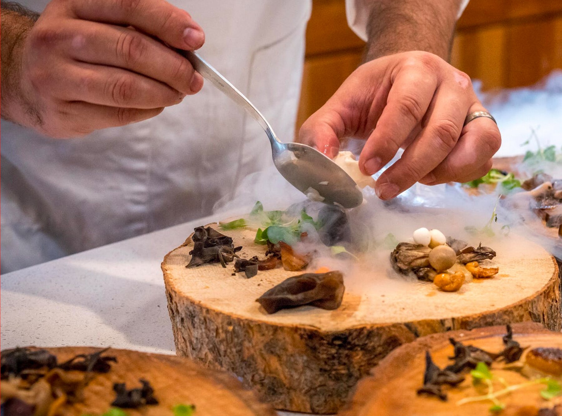 Chef plating a dish in the kitchen