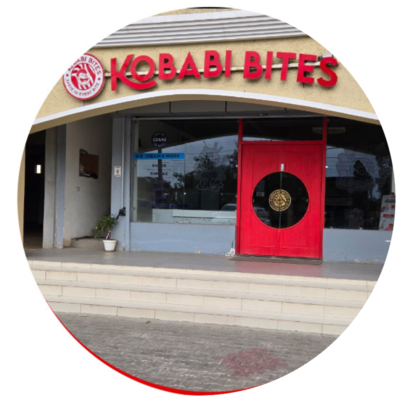 The Kobabi Bites storefront with its red doors and illuminated sign